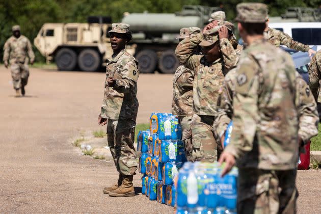 Members of the Mississippi National Guard hand out bottled water at a school in Jackson on Sept. 1 in response to the water crisis. (Photo: Brad Vest via Getty Images)